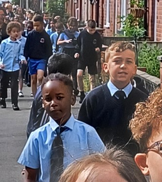 Large number of school children walking down the street