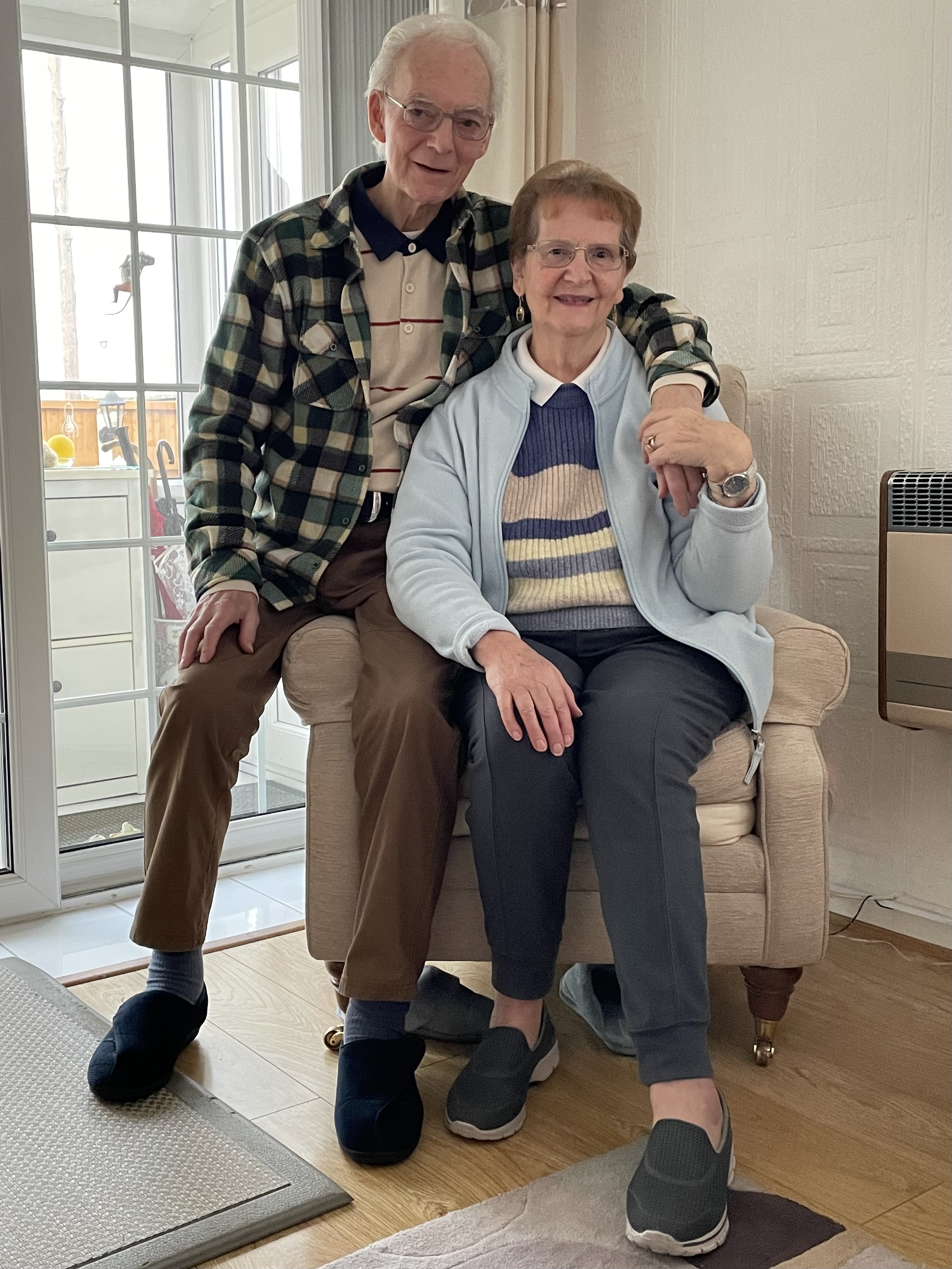 A man and a woman posing for a photo sat down
