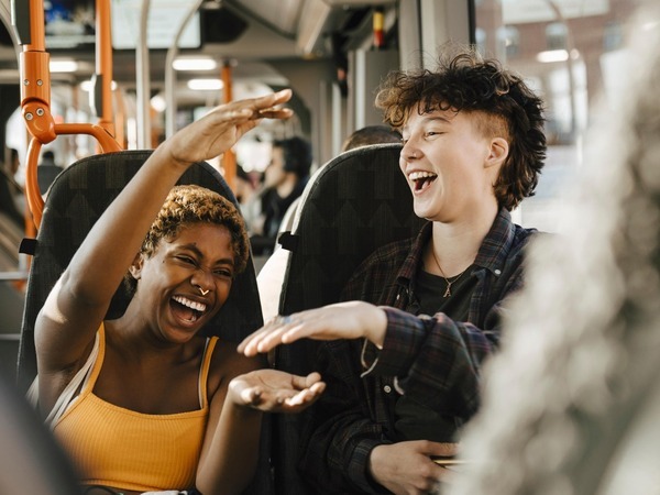 Young people laughing on a bus