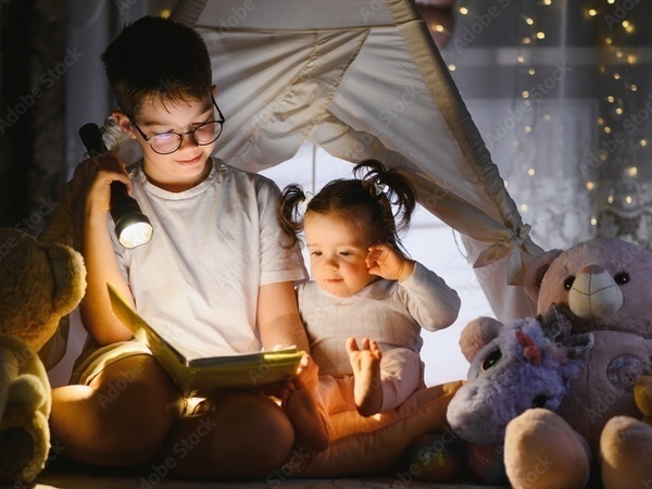 Siblings reading bedtime story together