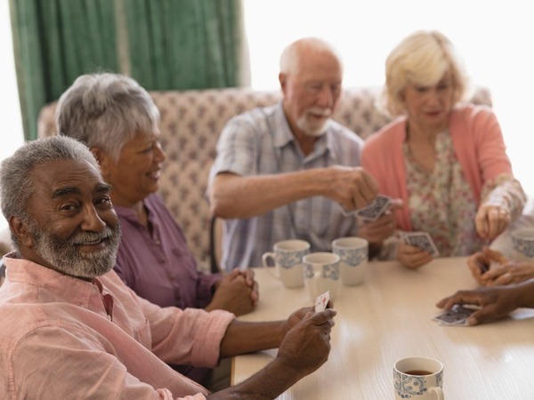 Group of older aged adults playing cards